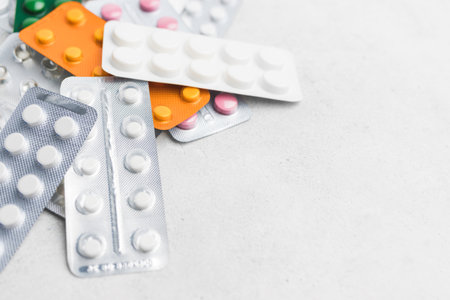 Pile of various pills and tablets in a blister pack on white background, healthcare and medicine...