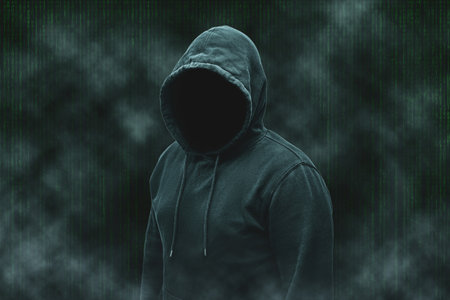 Mysterious faceless hooded anonymous computer hacker, silhouette of cybercriminal, terrorist.の写真素材
