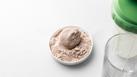 Whey protein powder in measuring scoop.の写真素材