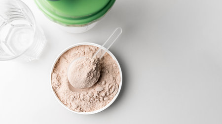 Whey protein powder in measuring scoop, top view.の写真素材