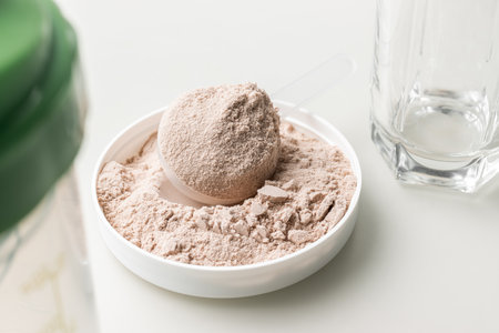 Whey protein powder in measuring scoop.の写真素材