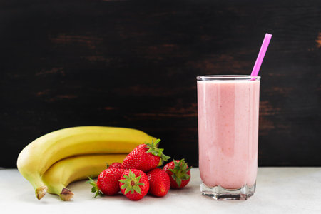 Strawberry and banana smoothie drink, blended cocktail, milkshake in a glass.の写真素材