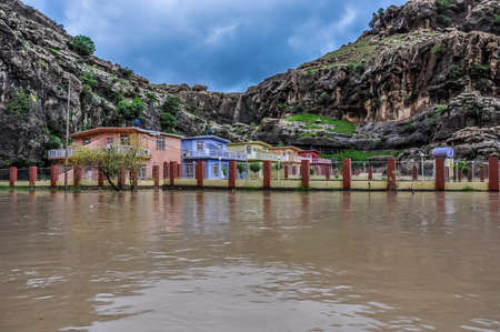 Tourist houses on the river between mountains in northern Iraq