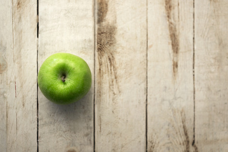 Close up of fresh green apple on a wooden background.の写真素材