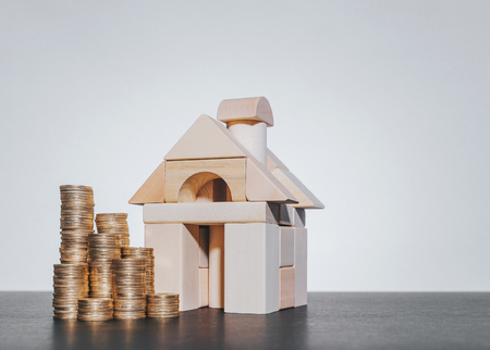 Property investment and house mortgage financial concept with wooden block