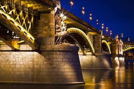 Beautifully lit Margaret bridge over the Danube at dusk in Budapest, Hungaryの写真素材