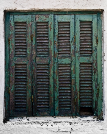 Achient wooden turquoise window on a white house in Sarti, Greeceの写真素材