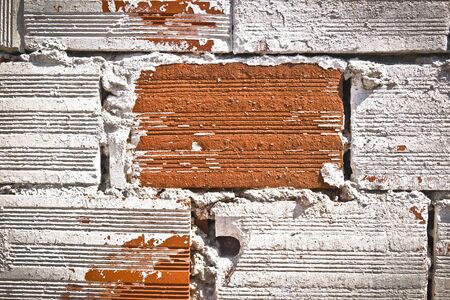 Weathered stained old brick wall backgroundの写真素材