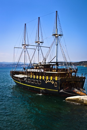 Vintage wooden ship sailing on the blue sea with blue skyの写真素材