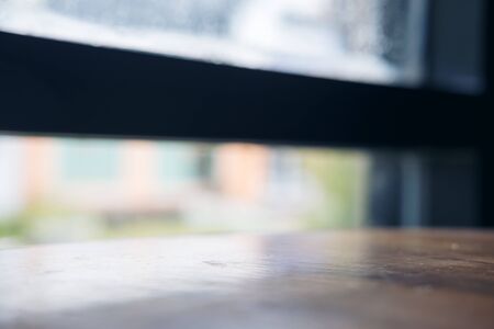 Wooden table in modern loft cafe with blur outdoor backgroundの写真素材