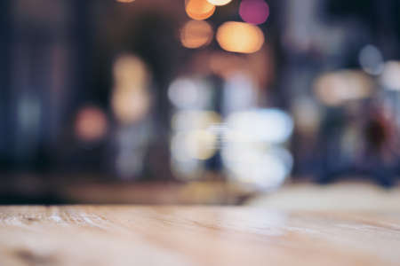 Wooden table in cafe with blur bokeh abstract vintage backgroundの写真素材