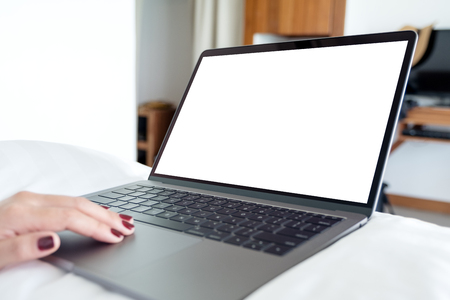 Mockup image of woman's hands using and touching on laptop with blank white desktopの写真素材