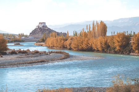 Stakna Gompa and Indus river before sunset with cloudy sky and mountains backgroundの写真素材