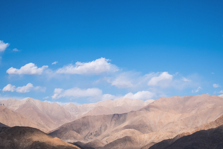 Closeup image of mountains and blue sky with clouds background in Ladakh , Indiaの写真素材
