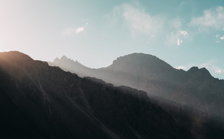 Mountains and blue sky while sunset in the background