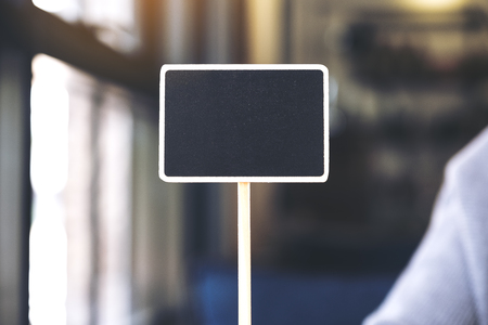 Closeup image of an empty small blackboard with blur backgroundの写真素材