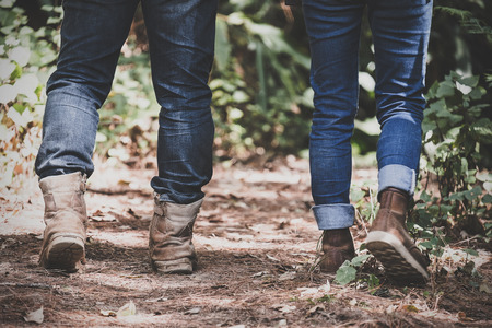Closeup image of two people trekking in a tropical forest togetherの写真素材