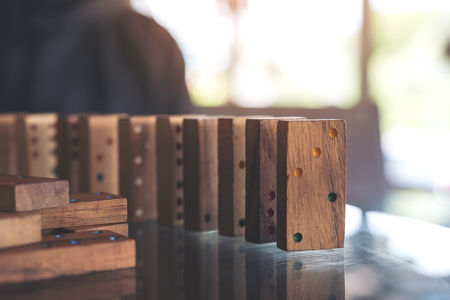 Closeup image of wooden domino game setting on tableの写真素材