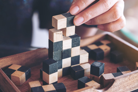 Closeup image of people playing and building wooden puzzle gameの写真素材