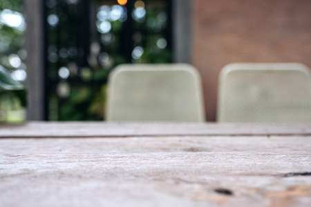 Wooden table and chair in cafe with blur bokeh abstract vintage backgroundの写真素材