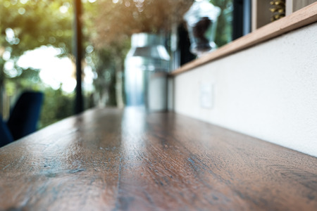 Closeup image of a wooden bar with flowerpots with blur green nature background