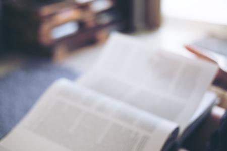 Blur image of a person reading a book in a houseの写真素材