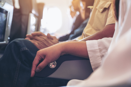 Passenger sitting on a seat row in cabinの写真素材