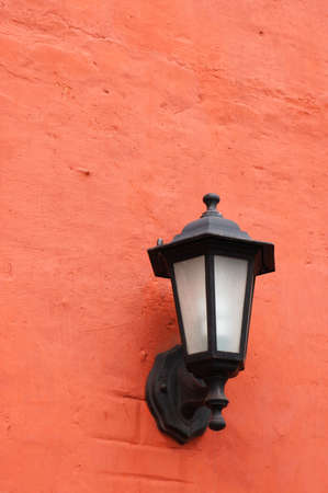 Old lantern on the colorful stucco wallの写真素材