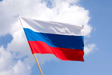 Russian flag on a background blue sky