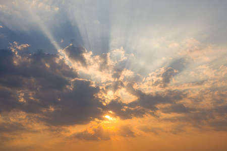 rays of light in the cloudy sky at the sunsetの写真素材