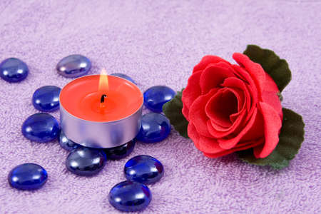 scented  rose and  aroma candle on a background lilac towelの写真素材