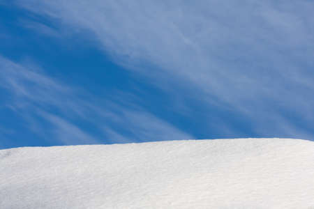 beautiful horizon with blue sky and snowy hilの写真素材