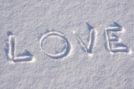 writing text " LOVE "  in sunny day on the snowの写真素材