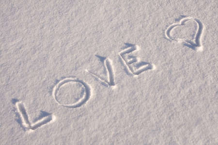 writing text  LOVE   on the snowの写真素材