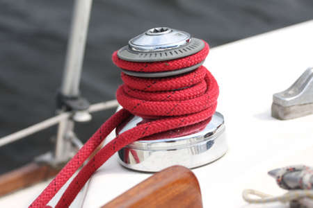 Winch and red rope on a sailboatの写真素材