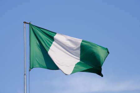 Flag of Nigeria on a background blue skyの写真素材