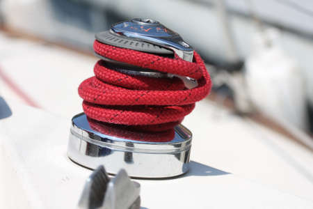 Winch and red rope on a sailboat の写真素材