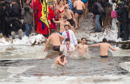KYIV, UKRAINE  JANUARY 19 : People dive in ice-holes in cold water in holiday the Christening . Holiday passed in the museum of  Mamajeva Sloboda  on January 19,2012 in Kyiv,Ukraine .のeditorial素材