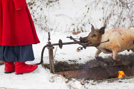 Ukrainian Cossack prepares a pig  on fireの写真素材