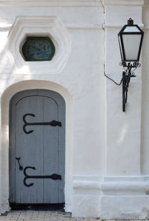 Ancient door with a lampの写真素材