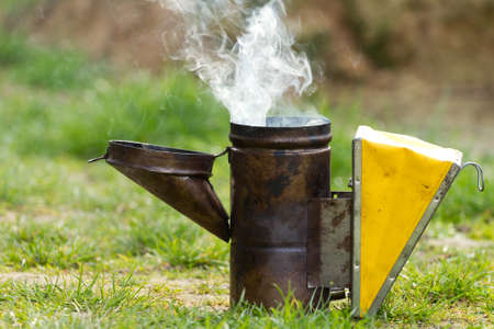 Open and smoking bee smoker .