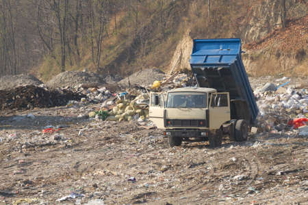 Garbage machines unload garbage on a municipal dump 