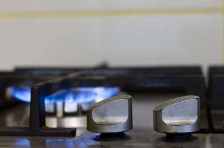 Turns on gas stove with burning flameの写真素材