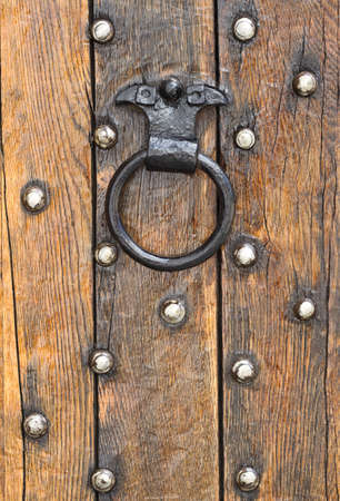 Old doorknocker of a wooden doorの写真素材