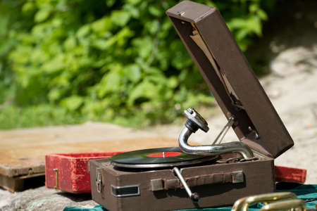 Vintage gramophone with vinyl plate on the streetの写真素材