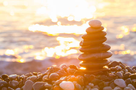 Pyramid of pebbles at sea in sunrise in Kemer