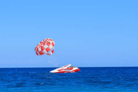 Kiris, Turkey - June 17, 2018: Powerboat with parachute in the turquoise sea in Kiris, Turkeyのeditorial素材
