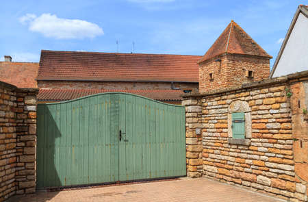 Burgundy, France- June 5, 2010:Entrance gate and old house in a french village in Burgundy, Franceのeditorial素材