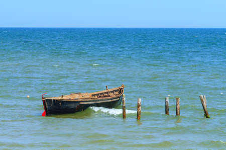 Fishing boat anchored in the blue seaの写真素材