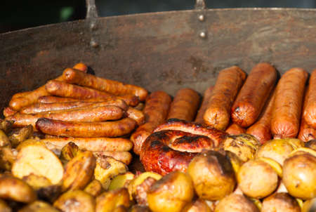 Fried sausage with vegetables and potatoes at the christmas marketの写真素材